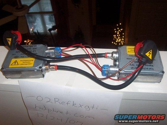 Two HID ballast units with wiring and warning labels