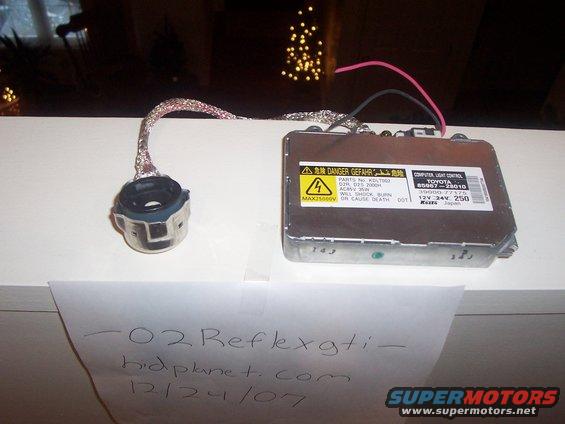 Car headlight ballast and connector with Toyota branding and warning labels