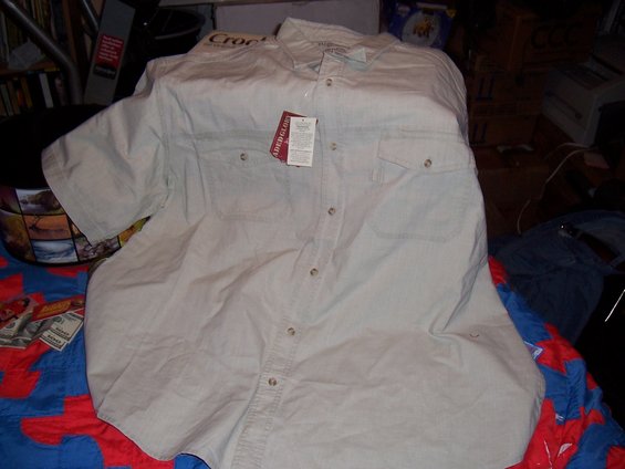 Beige short-sleeve button-up shirt with two chest pockets and tags attached