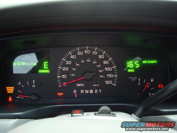 Dashboard gauges showing 070641 miles, E for empty, compass, and 165 miles to empty