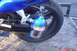 2002 Suzuki VL 1500 Intruder Classic - Close-up of a motorcycle's rear wheel and swingarm, showing a blue NOS nitrous oxide bottle.