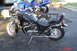 2002 Suzuki VL 1500 Intruder Classic - A black cruiser motorcycle is parked on a trailer, with a blue sportbike behind it.