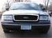 1999 Ford Crown Victoria - Front view of a black Ford Crown Victoria with a honeycomb grille and a Minnesota license plate.