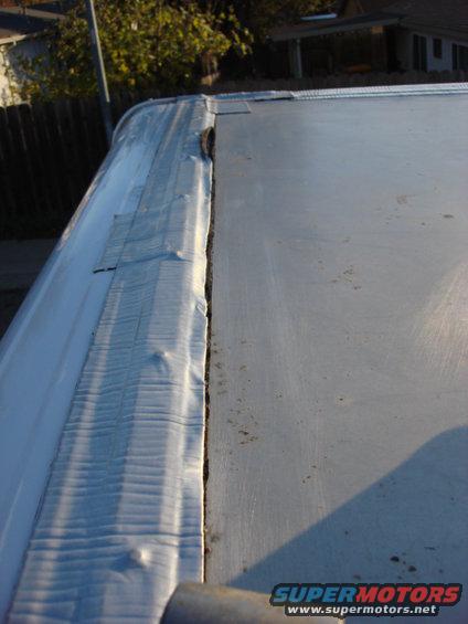 roof-patch-rear.jpg I had a leak in the front end so i went over the whole top seal. the rear looked in need of help. There was some inside damage a few years back that was fixed, but the rooof was still bad. Here is the roof as i started it. You can see where it had lifted and allowed water under the seal.