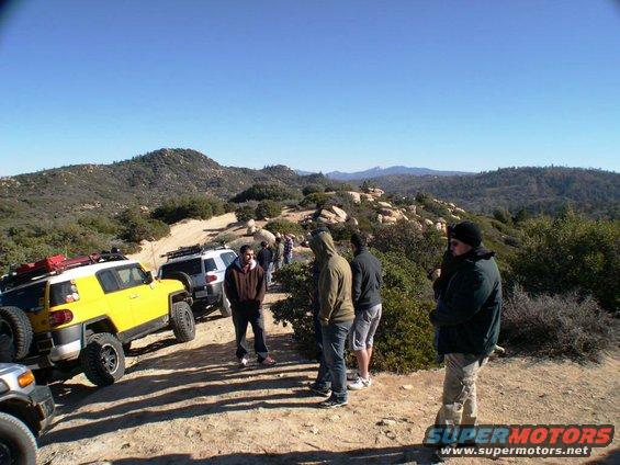 Yellow 2007 Toyota FJ Cruiser on a dirt road with a white FJ Cruiser behind it