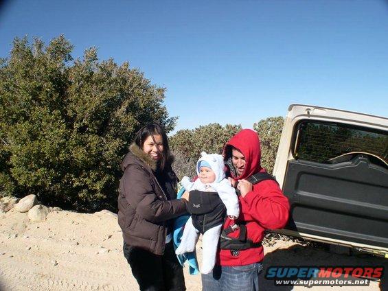 White 2007 Toyota FJ Cruiser rear view with open tailgate and family