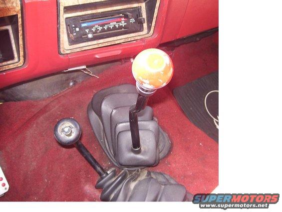 1986 Ford Bronco interior showing two gear shifters and the dashboard radio