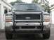 2000 Ford Excursion - The front of a Ford Excursion is shown, a chrome grille and a protective grille guard.