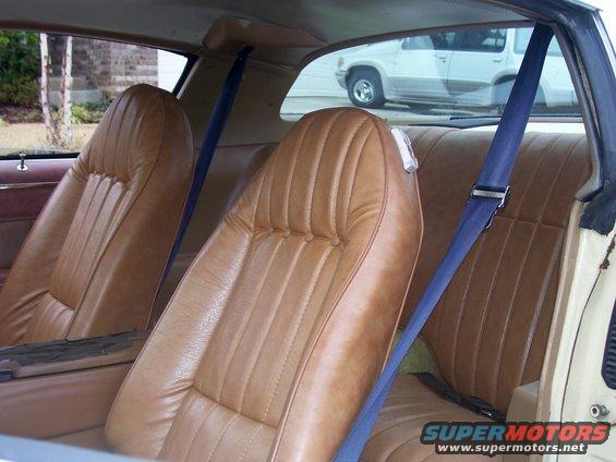 Interior view of 1979 Chevrolet Camaro showing tan vinyl seats and blue seatbelts