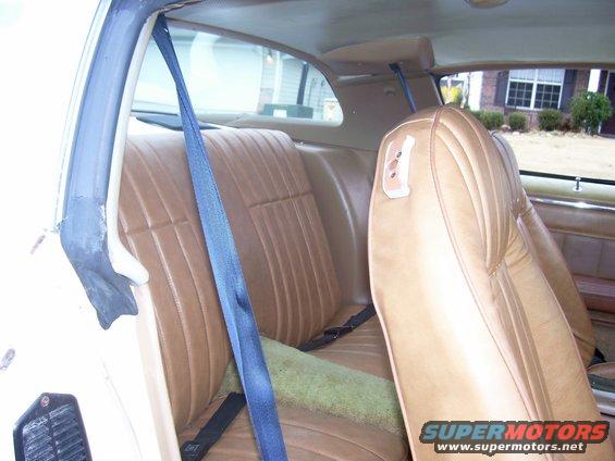 1979 Chevrolet Camaro interior with tan vinyl seats and blue seatbelts