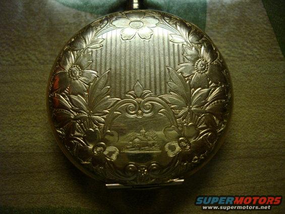 Engraved gold pocket watch with floral motifs and a central landscape scene