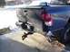 1981 Ford Bronco - The rear of a dark-colored pickup truck shows significant damage to the tailgate and bumper area.