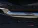 1981 Ford Bronco - A close-up view of a vehicle's rear bumper and exhaust pipe, with a landscape reflected on the chrome.