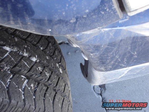 Blue vehicle fender and tire with snow on tread. Timestamp 11:11AM