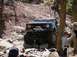 1976 Ford Bronco - This 1976 Ford Bronco is shown tackling a challenging off-road course with its front end prominently displayed.