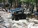 1976 Ford Bronco - Off-road enthusiasts navigate a challenging rocky path in a 1976 Ford Bronco.