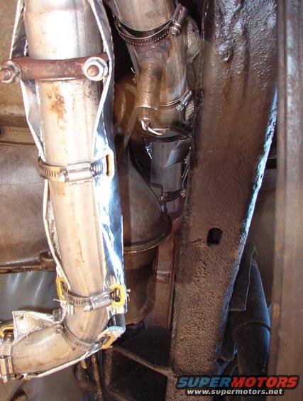 exhwrap03.jpg To keep even more heat out, all the exhaust pipes near the body are now wrapped. This stuff smokes & stinks the first few times the engine heats up.

I wanted to build a Y-pipe & put the oxygen sensor in a little crossover like the factory did, but this true-dual system got installed during Phase 2.