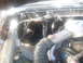 1992 Ford Bronco - The engine bay of a vehicle is shown, with various components and wiring exposed.