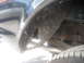 1992 Ford Bronco - Close-up view of the rear wheel well and suspension, showing damage to the liner and visible suspension parts.