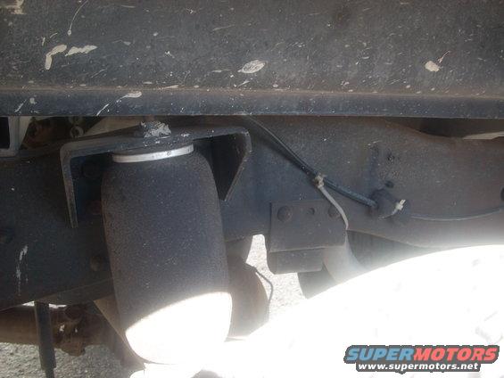Close-up of an air suspension bellows mounted to a vehicle frame