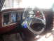 1992 Ford Bronco - The interior of a vintage vehicle shows a dashboard with a steering wheel and various controls, along with a watermark at the bottom.