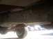 1992 Ford Bronco - A view of the undercarriage of a vehicle, showing the frame and drivetrain components.