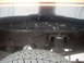 1992 Ford Bronco - Close-up view of the rear suspension and tire, showing the undercarriage of the vehicle.