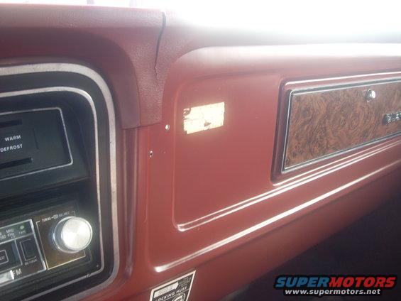 Red dashboard interior with wood grain trim and a radio