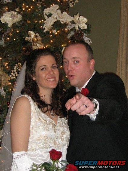 Wedding couple in front of a decorated Christmas tree