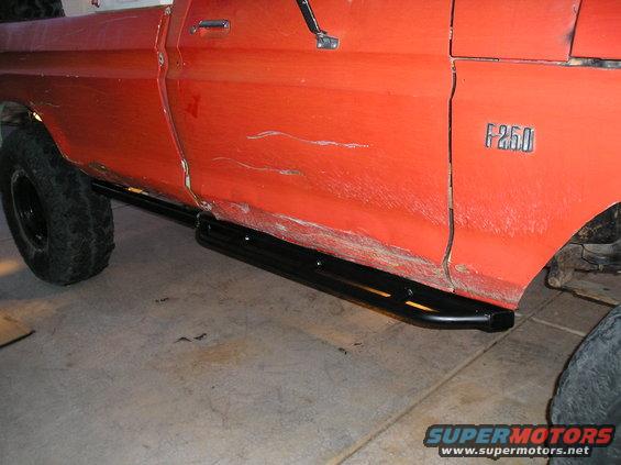 Orange Ford F-250 pickup truck side with running boards and F-250 badge