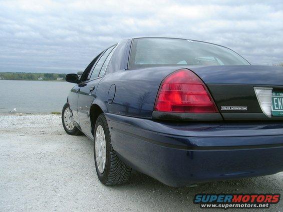 2003 Ford Crown Victoria Police Interceptor, rear quarter view, parked on gravel near water. License plate EKB-797