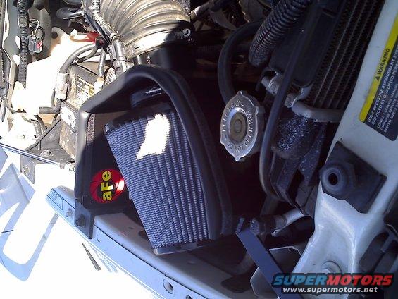 Engine bay with blue aftermarket air filter and aFe logo