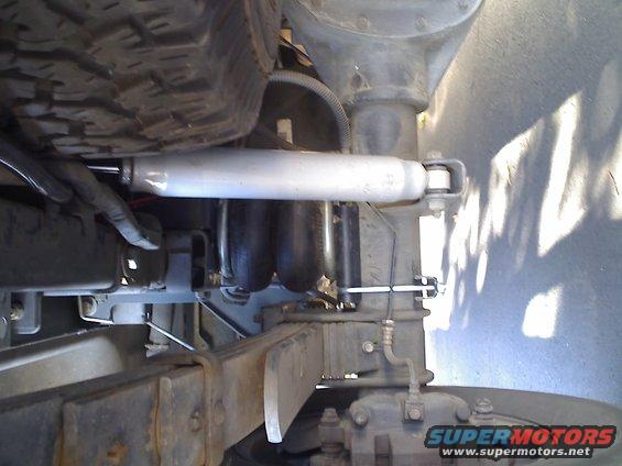Rear suspension components including leaf springs, air bags, and a shock absorber