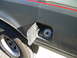 1991 Ford Bronco - The fuel door is open, revealing the gas cap receptacle and a portion of the vehicle's tire.