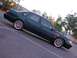 1995 Ford Taurus - A dark green 1995 Ford Taurus SHO is parked in an outdoor lot with trees in the background.