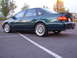 1995 Ford Taurus - The rear view of a dark green 1995 Ford Taurus SHO sedan parked in a lot.