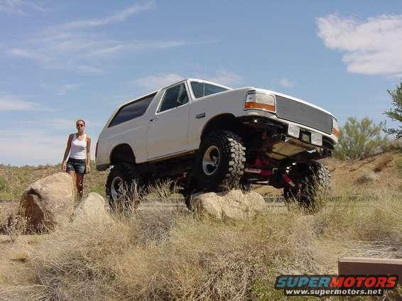 White lifted 1992 Ford Bronco on rocks