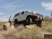 1992 Ford Bronco - A white 1992 Ford Bronco is positioned on rocks in a desert landscape.