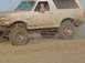 1992 Ford Bronco - This 1992 Ford Bronco is covered in mud as it drives through a watery terrain.