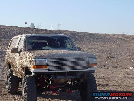 Mud-covered 1992 Ford Bronco 3q-front view with custom grille