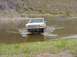 1992 Ford Bronco - White 1992 Ford Bronco fording a body of water.