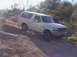 1992 Ford Bronco - A white 1992 Ford Bronco navigates a steep, dusty incline in a natural landscape.