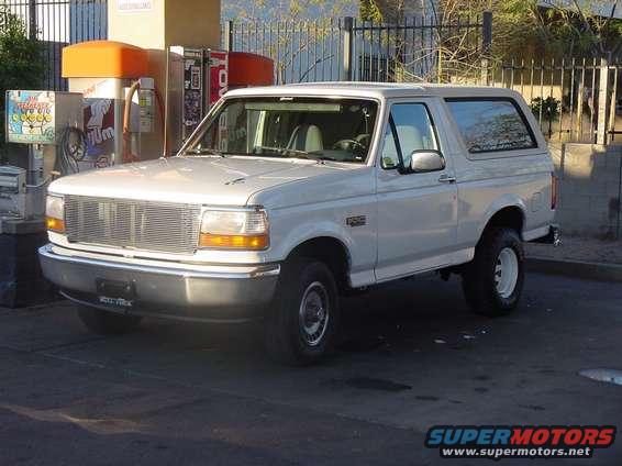 White 1992 Ford Bronco parked at a gas station