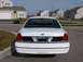 1999 Ford Crown Victoria - Rear view of a white Ford Crown Victoria, showing its taillights and black trim panel.