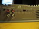 1992 Ford Crown Victoria - Close-up view of a car amplifier, showing various control knobs and input/output connections.