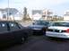 1999 Ford Crown Victoria - Three Ford Crown Victorias are parked in front of suburban houses.