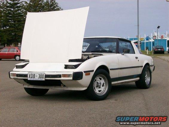 White 1983 Mazda RX-7, 3q-front view, hood open. License plate XDB 300