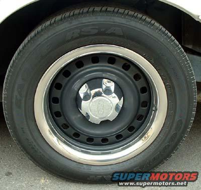 Close-up of a steel wheel with a chrome trim ring and a Ford center cap