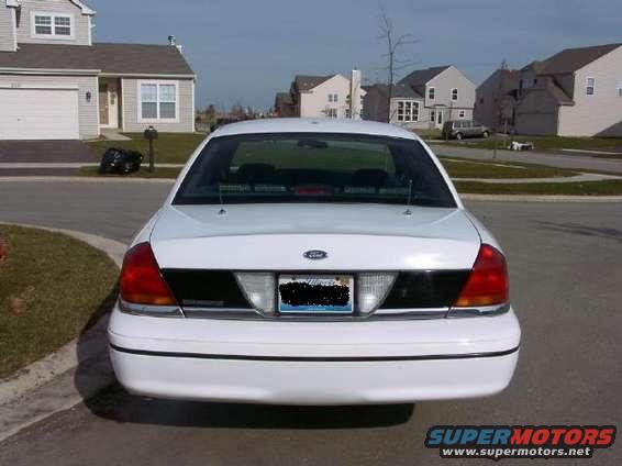 Rear view of a white Ford Crown Victoria parked on a suburban street