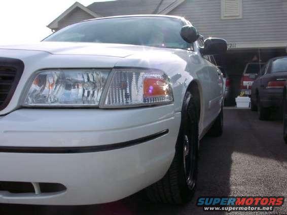 White 1998 Ford Crown Victoria front corner with black trim and chrome grille